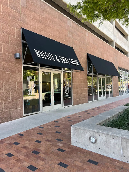 The exterior of Whistle & Sway Salon Company at 701 Barden St Suite 101 in the Fort Worth Cultural District, black awning with the salon name